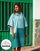 Lead_women - Woman wears a Vivida Original Adult Poncho Towel Changing Robe - Turquoise Teal / Pacific Teal. Sticker reads Women's Health Best Towelling Changing Robe