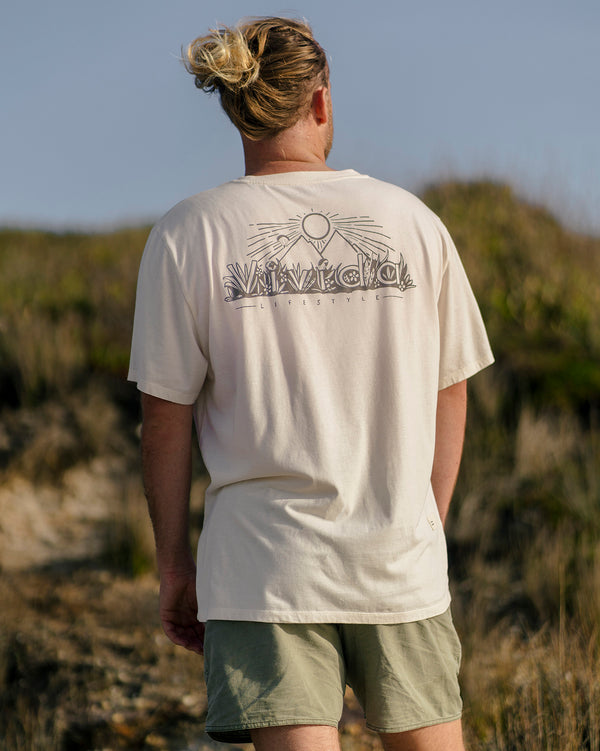 Lead_men - man wearing a Vivida Lifestyle Into the Wild Classic Organic Cotton T-Shirt in Beach Ivory