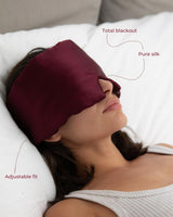 Woman wearing a Vivida Silk Blackout Eye Mask - Burgundy Berry