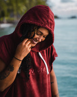 Woman holding hood wearing Essential Adult Poncho Towel Changing Dry Robe Rhubarb Red