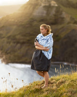 Woman wearing a Vivida Premium Poncho Towel Changing Robe - Cloud Blue Map of Dreams