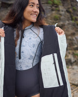 Lead_women2 - Woman wearing a Vivida Lifestyle All Weather Puffer Changing Robe, Matcha Green Drying Robe for swimming standing in snow. Sticker: Best Premium Changing Robe - The Independent.