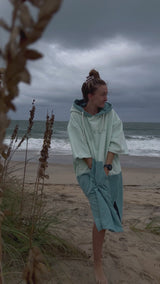 Woman wearing Original Poncho Towel Changing Dry Robe Seafoam Green on beach