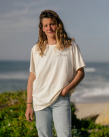 Lead woman wearing a Vivida Lifestyle Into the Wild Classic Organic Cotton T-Shirt in Beach Ivory