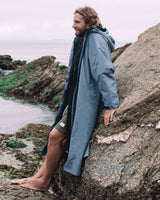 Lead Man wearing the All Weather Sherpa Changing Robe - Mineral Blue