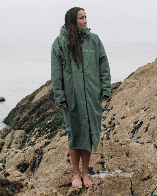Lead_women - Woman wearing a Vivida sherpa weatherproof changing robe Green Map of Dreams