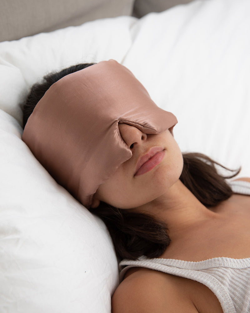 Lead_women wearing a Silk Blackout Sleep Eye Mask - Misty Rose