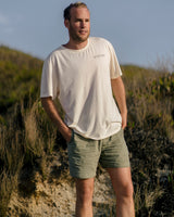 Lead_men2 - Man wearing a Vivida Lifestyle Into the Wild Classic Organic Cotton T-Shirt in Beach Ivory