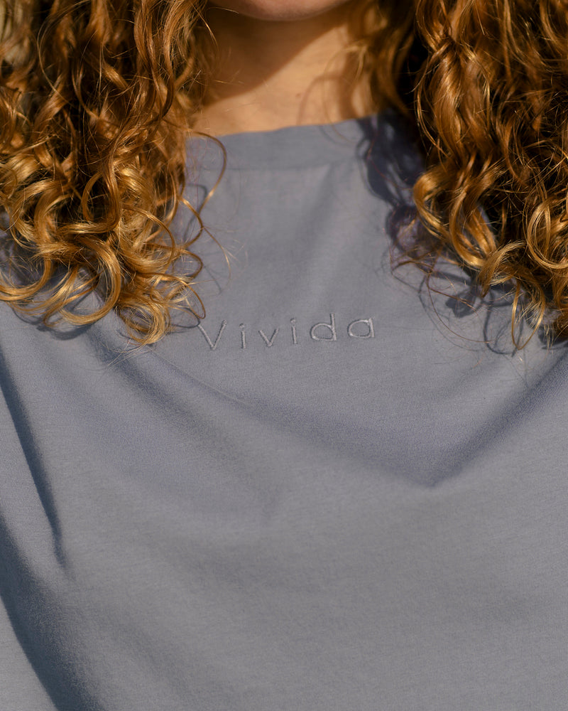 Woman wearing a Vivida Lifestyle Classic Tee Embroidered T-Shirt Celestial Blue