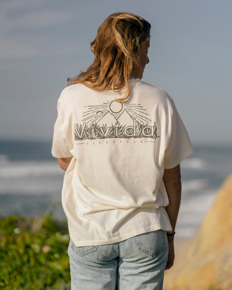 Woman wearing a Vivida Lifestyle Into the Wild Classic Organic Cotton T-Shirt in Beach Ivory