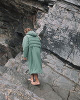 Man from back wearing a Vivida All Weather Puffer Changing Robe - Aventurine Green