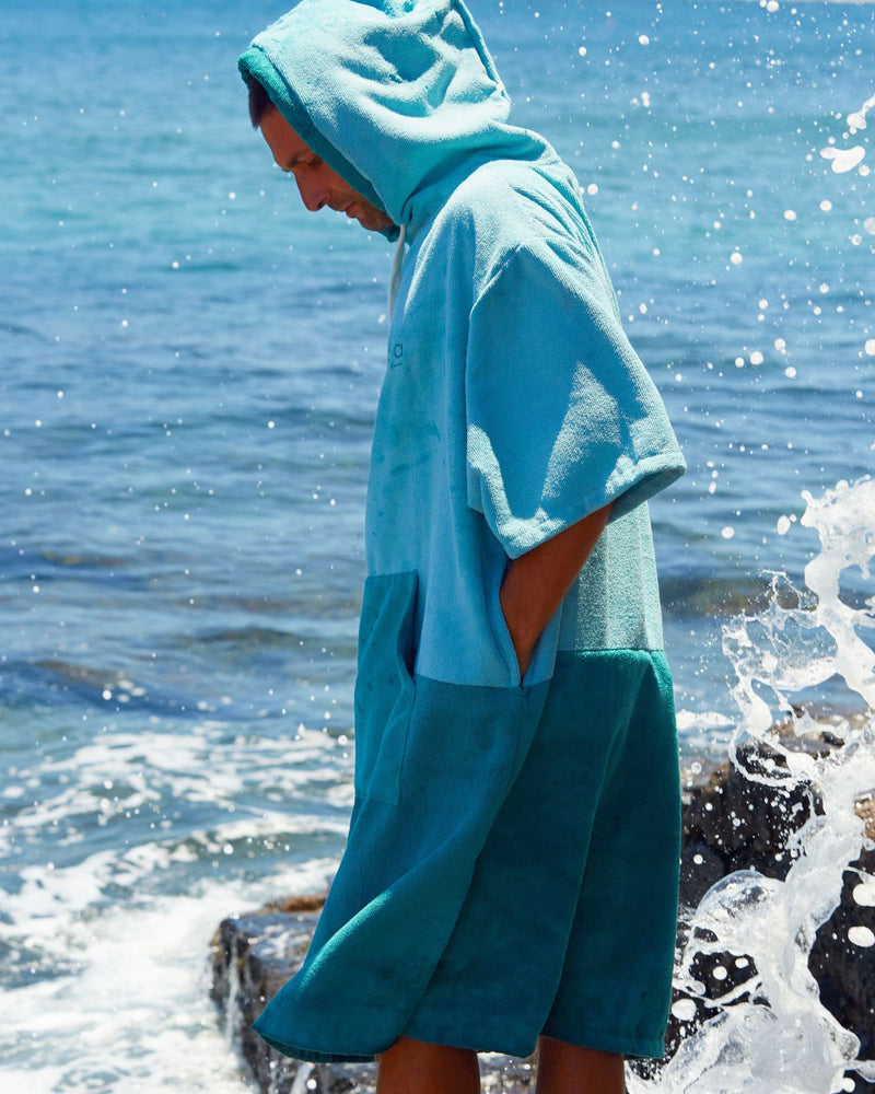 Lead_men2 - Man wears a Vivida Original Poncho Towel Changing Robe - Turquoise Teal / Pacific Teal