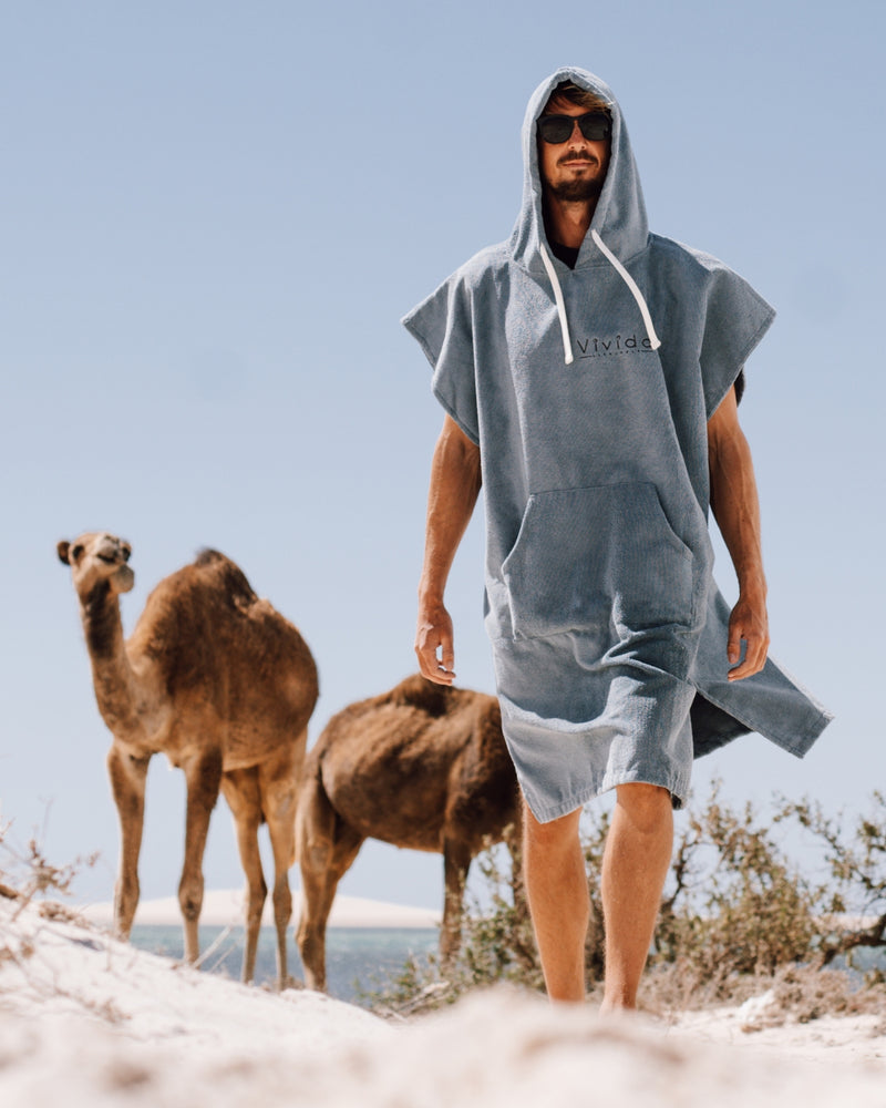 Man wearing Essential Poncho Towel Changing Dry Robe Mineral Blue