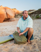 Lead_men2 - man wears a Vivida Original Poncho Towel Changing Robe - Seafoam Green