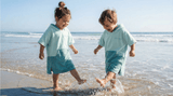 Two children playing in the water at the beach