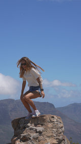 Lucia Pele wears the Into The Wild tee on a mountain hike