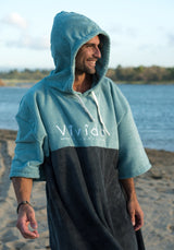 Man wearing Essential Poncho Towel Dry Robe Teal Anthracite Grey