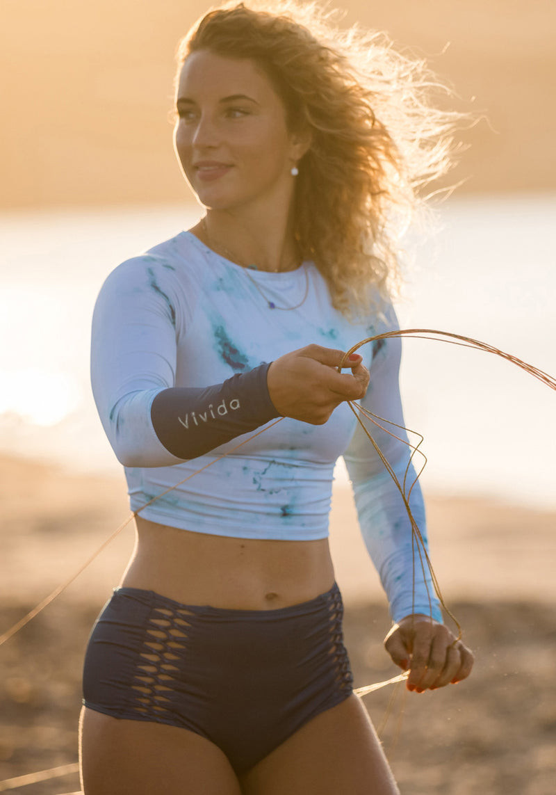 Woman wears Women of the Sea Surf Rashguard Dreamy Blue