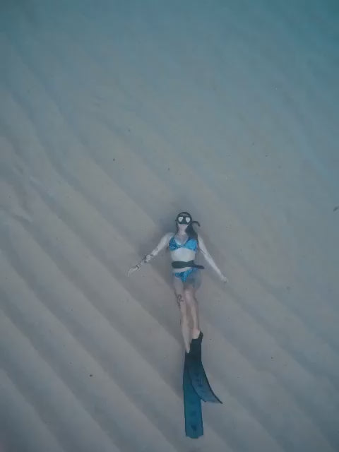 Woman swimming wearing Hermosa Surf Bikini Top and Bottoms Bamboo Tropics